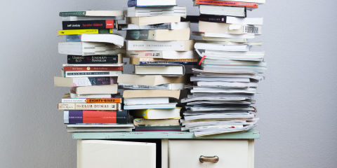 Stacks of books on a cabinet