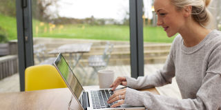 Woman smiling on laptop